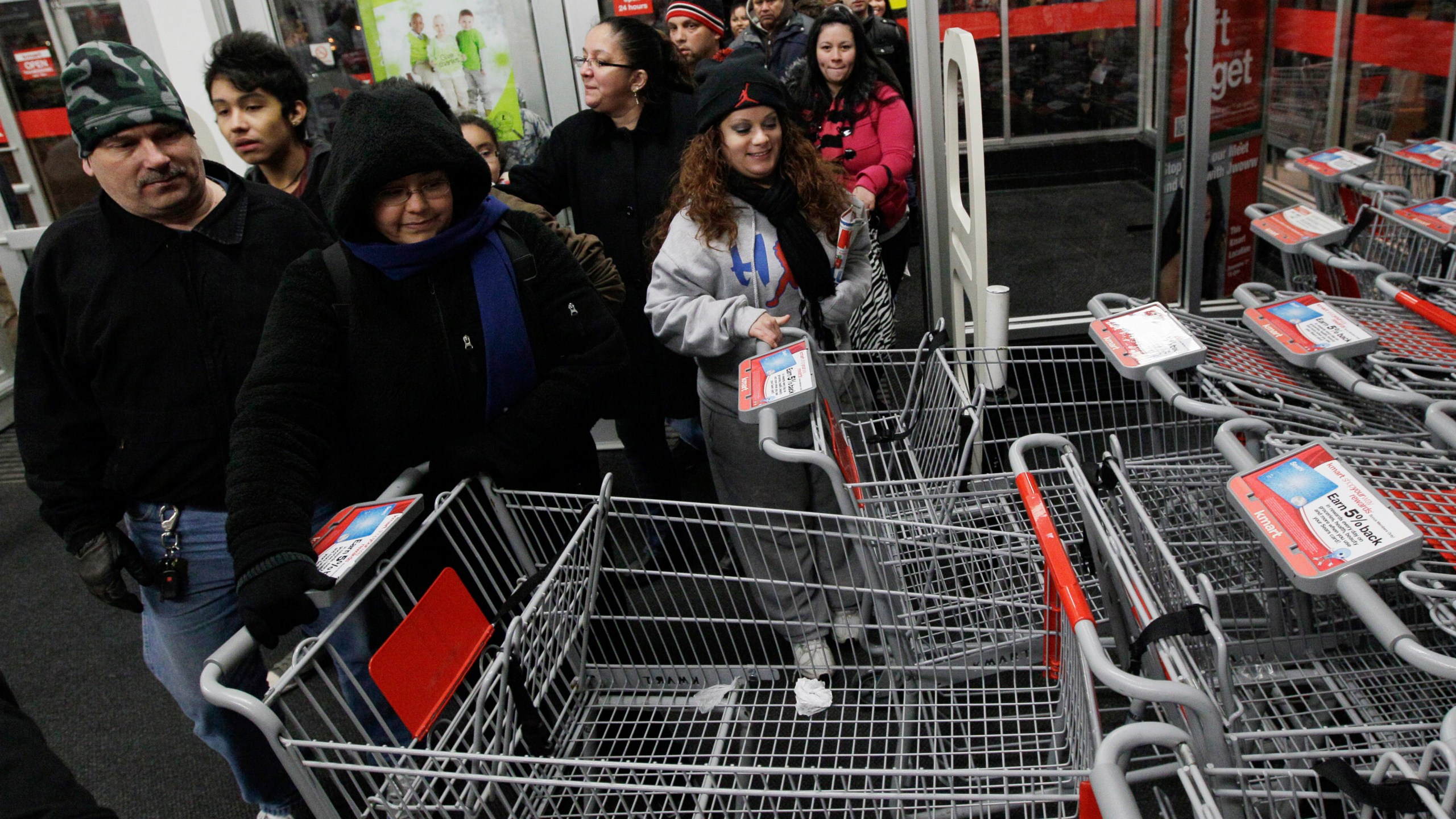 FILE - Shoppers rush into a Kmart store in Chicago on on Nov. 25, 2011 for Black Friday sale. (AP Photo/Nam Y. Huh, File)