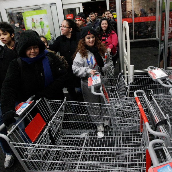 FILE - Shoppers rush into a Kmart store in Chicago on on Nov. 25, 2011 for Black Friday sale. (AP Photo/Nam Y. Huh, File)