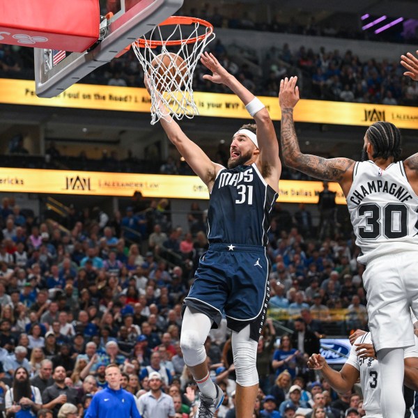 Dallas Mavericks' guard Klay Thompson (31) goes for a layup as he is guarded by San Antonio Spurs' forward Julian Champagnie (30) during the second half of an NBA basketball game, Thursday, Oct. 24, 2024, in Dallas, Texas. (AP Photo/Albert Pena)