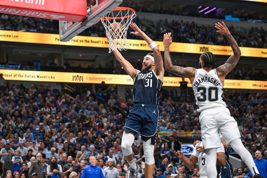 Dallas Mavericks' guard Klay Thompson (31) goes for a layup as he is guarded by San Antonio Spurs' forward Julian Champagnie (30) during the second half of an NBA basketball game, Thursday, Oct. 24, 2024, in Dallas, Texas. (AP Photo/Albert Pena)