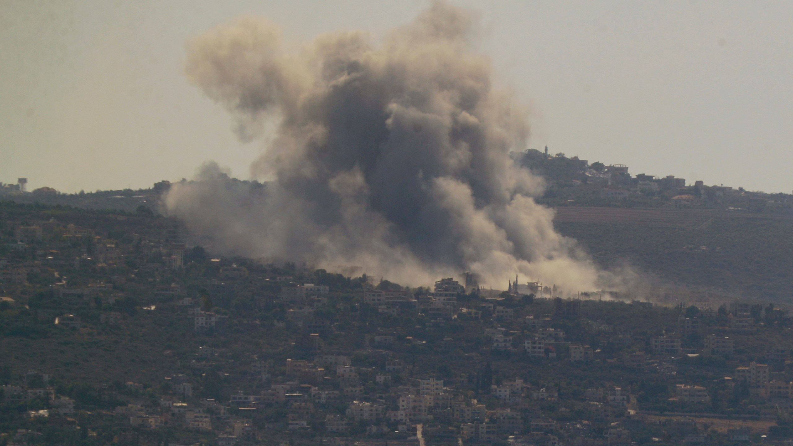 Smoke rises from an Israeli airstrike on Mansouri village, as it seen from the southern city of Tyre, south Lebanon, Thursday, Oct. 24, 2024. (AP Photo/Mohammed Zaatari)