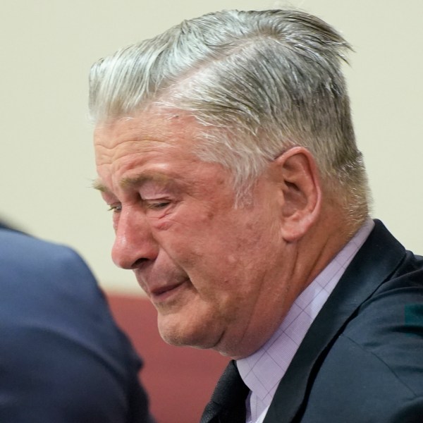 FILE - Actor Alec Baldwin, center, reacts as he sits between his attorneys Alex Spiro, left, and Luke Nikas after the judge threw out the involuntary manslaughter case for the 2021 fatal shooting of cinematographer Halyna Hutchins during filming of the Western movie "Rust," Friday, July 12, 2024, in Santa Fe, N.M. (Ramsay de Give/Pool Photo via AP, File)