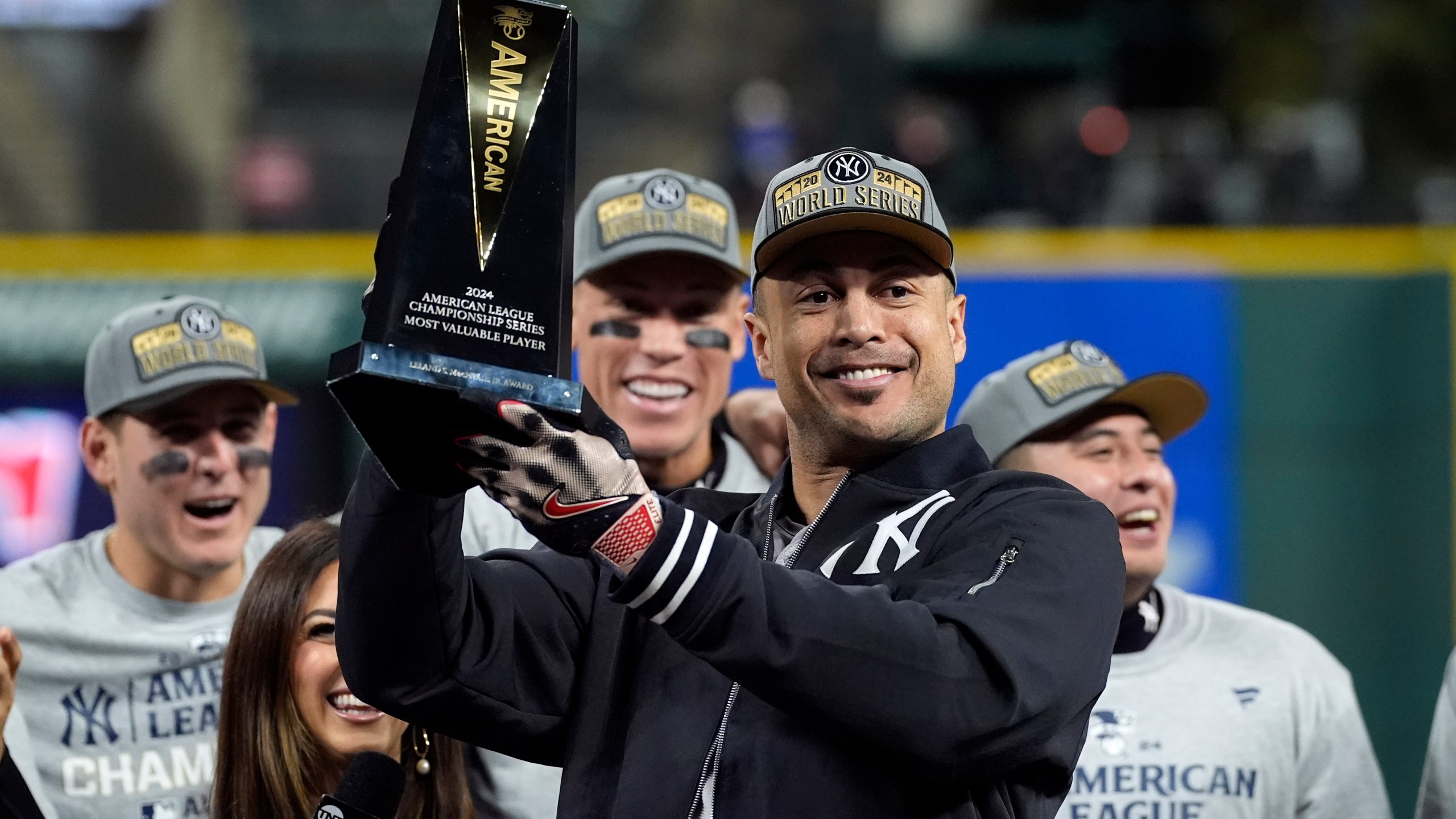 New York Yankees' Giancarlo Stanton holds up the MVP trophy after Game 5 of the baseball AL Championship Series Sunday, Oct. 20, 2024, in Cleveland. The Yankees won 5-2 to advance to the World Series. (AP Photo/Godofredo A. Vásquez )