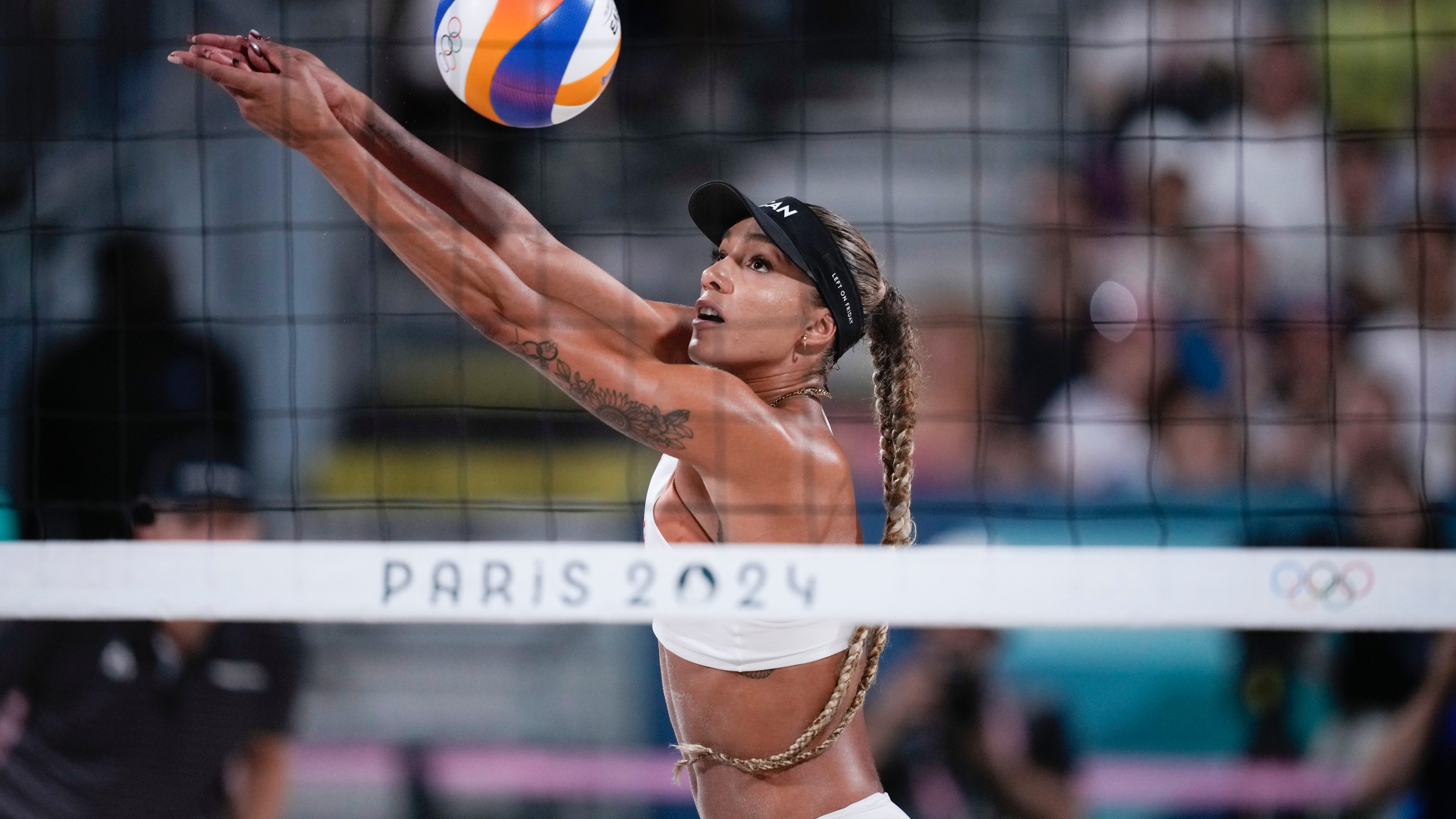 FILE - Canada's Brandie Wilkerson returns thea ball in the women's beach volleyball gold medal match between Brazil and Canada, at the 2024 Summer Olympics, Aug. 9, 2024, in Paris, France. (AP Photo/Louise Delmotte, File)