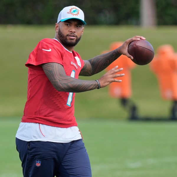 Miami Dolphins quarterback Tua Tagovailoa (1) aims the ball during a practice session at the team's training facility, Wednesday, Oct. 23, 2024, in Miami Gardens, Fla. (AP Photo/Marta Lavandier)