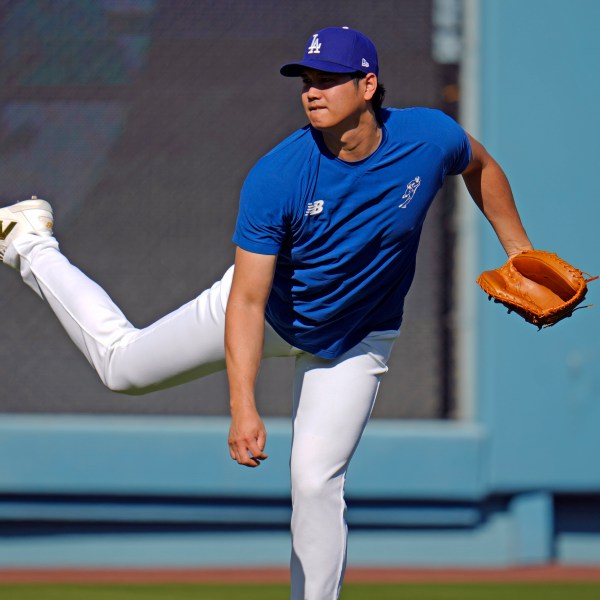 Los Angeles Dodgers Shohei Ohtani throws during batting practice before Game 1 of the baseball World Series, Friday, Oct. 25, 2024, in Los Angeles. (AP Photo/Julio Cortez)