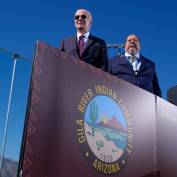 President Joe Biden, left, joined by Stephen Roe Lewis, Governor of the Gila River Indian Community, arrives to speak at the Gila Crossing Community School in the Gila River Indian Community reservation in Laveen, Ariz., Friday, Oct. 25, 2024. (AP Photo/Manuel Balce Ceneta)