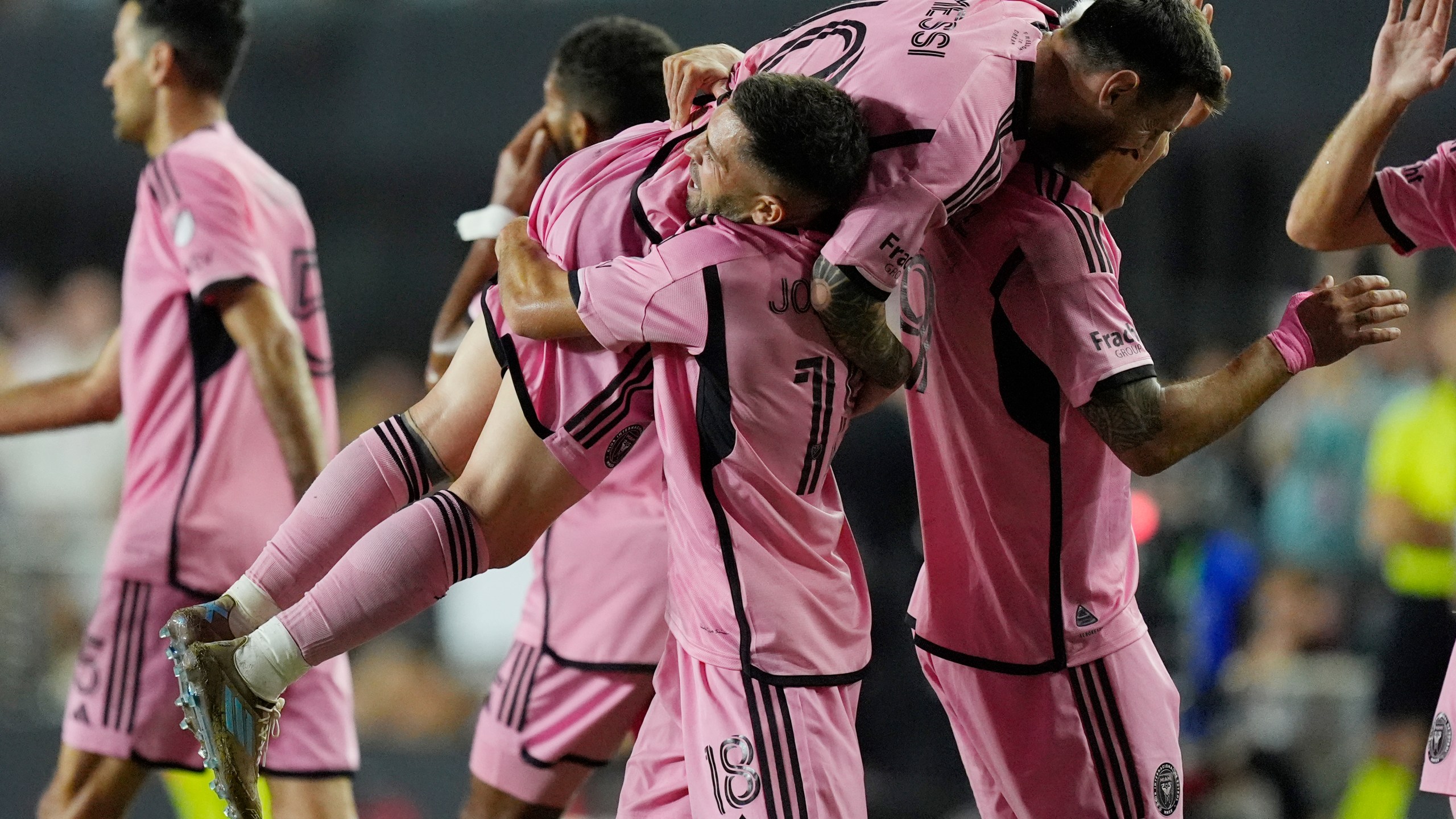 Inter Miami defender Jordi Alba (18) lifts Inter Miami forward Lionel Messi (10) after Alba scored a goal during the second half of match one of their MLS playoff opening round soccer match against Atlanta United, Friday, Oct. 25, 2024, in Fort Lauderdale, Fla. (AP Photo/Rebecca Blackwell)