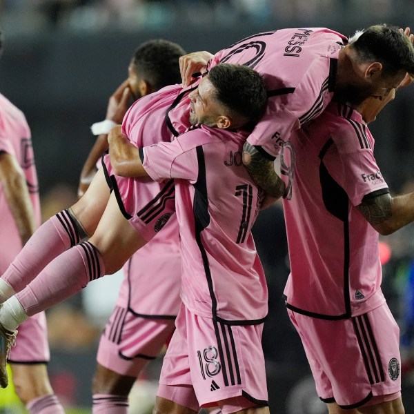 Inter Miami defender Jordi Alba (18) lifts Inter Miami forward Lionel Messi (10) after Alba scored a goal during the second half of match one of their MLS playoff opening round soccer match against Atlanta United, Friday, Oct. 25, 2024, in Fort Lauderdale, Fla. (AP Photo/Rebecca Blackwell)