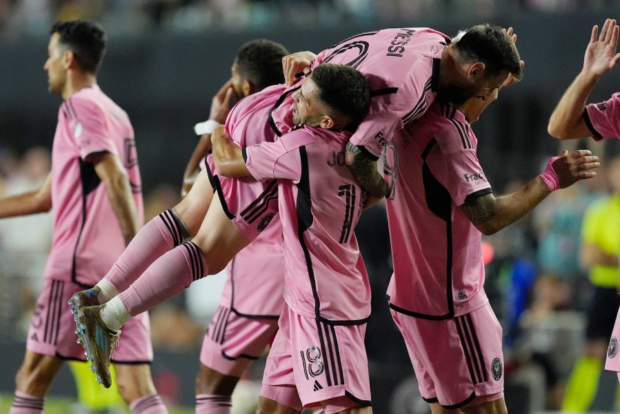 Inter Miami defender Jordi Alba (18) lifts Inter Miami forward Lionel Messi (10) after Alba scored a goal during the second half of match one of their MLS playoff opening round soccer match against Atlanta United, Friday, Oct. 25, 2024, in Fort Lauderdale, Fla. (AP Photo/Rebecca Blackwell)