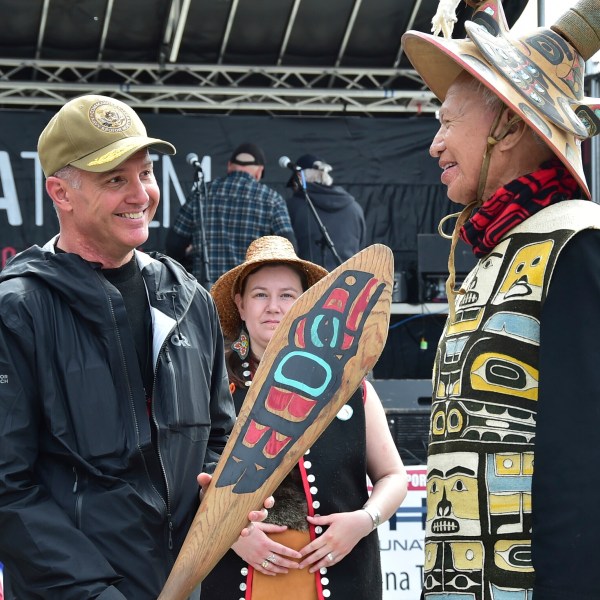 In this photo provided by the U.S. Navy, Commander of Navy Region Northwest Rear Adm. Mark Sucato is gifted a canoe paddle by Leonard John, Raven Clan, Native Village of Angoon, following the One People Canoe Society's welcoming ceremony to kick off the annual Juneau Maritime Festival on May 4, 2024, in Juneau, Alaska. (Chief Mass Communication Spc. Gretchen Albrecht/U.S. Navy via AP)