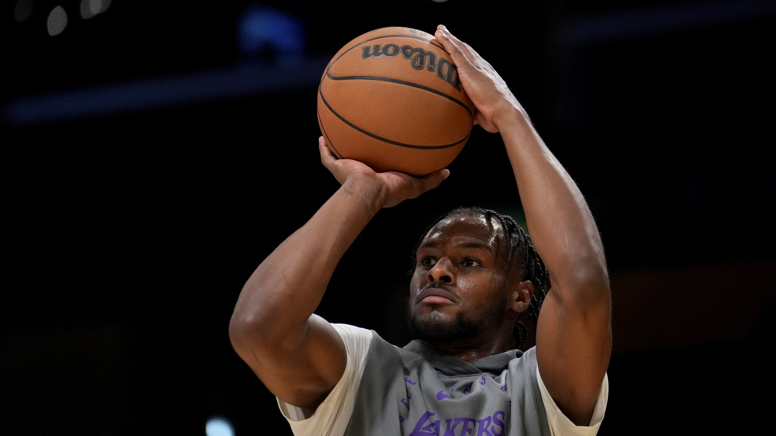 Los Angeles Lakers guard Bronny James warms up before an NBA basketball game against the Phoenix Suns in Los Angeles, Friday, Oct. 25, 2024. (AP Photo/Eric Thayer)