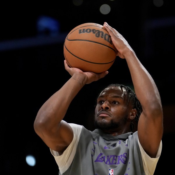 Los Angeles Lakers guard Bronny James warms up before an NBA basketball game against the Phoenix Suns in Los Angeles, Friday, Oct. 25, 2024. (AP Photo/Eric Thayer)