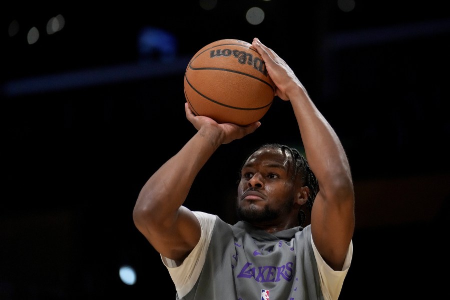 Los Angeles Lakers guard Bronny James warms up before an NBA basketball game against the Phoenix Suns in Los Angeles, Friday, Oct. 25, 2024. (AP Photo/Eric Thayer)