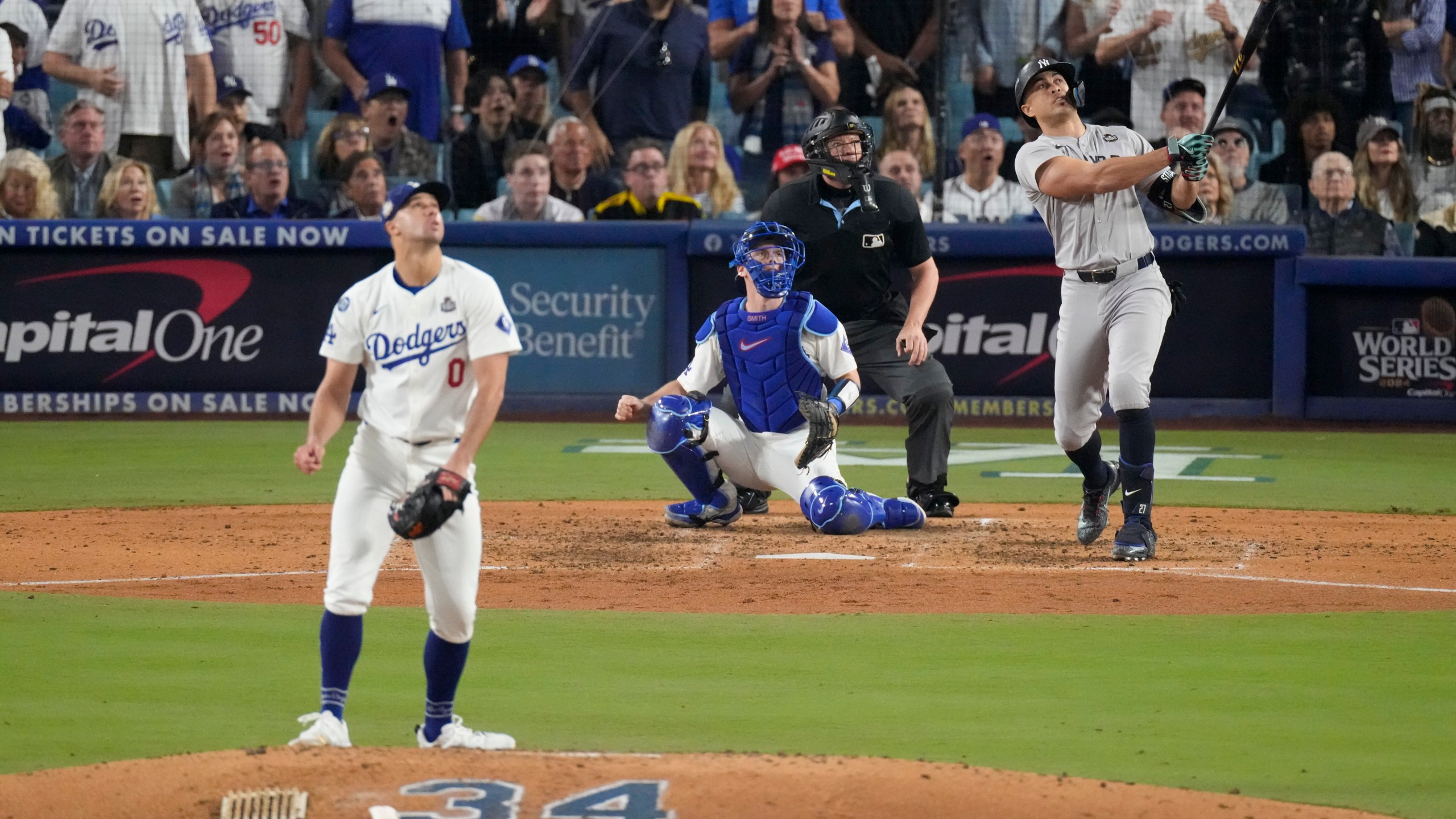 New York Yankees' Giancarlo Stanton watches his two-run home off Los Angeles Dodgers starting pitcher Jack Flaherty during the sixth inning in Game 1 of the baseball World Series, Friday, Oct. 25, 2024, in Los Angeles. (AP Photo/Mark J. Terrill)