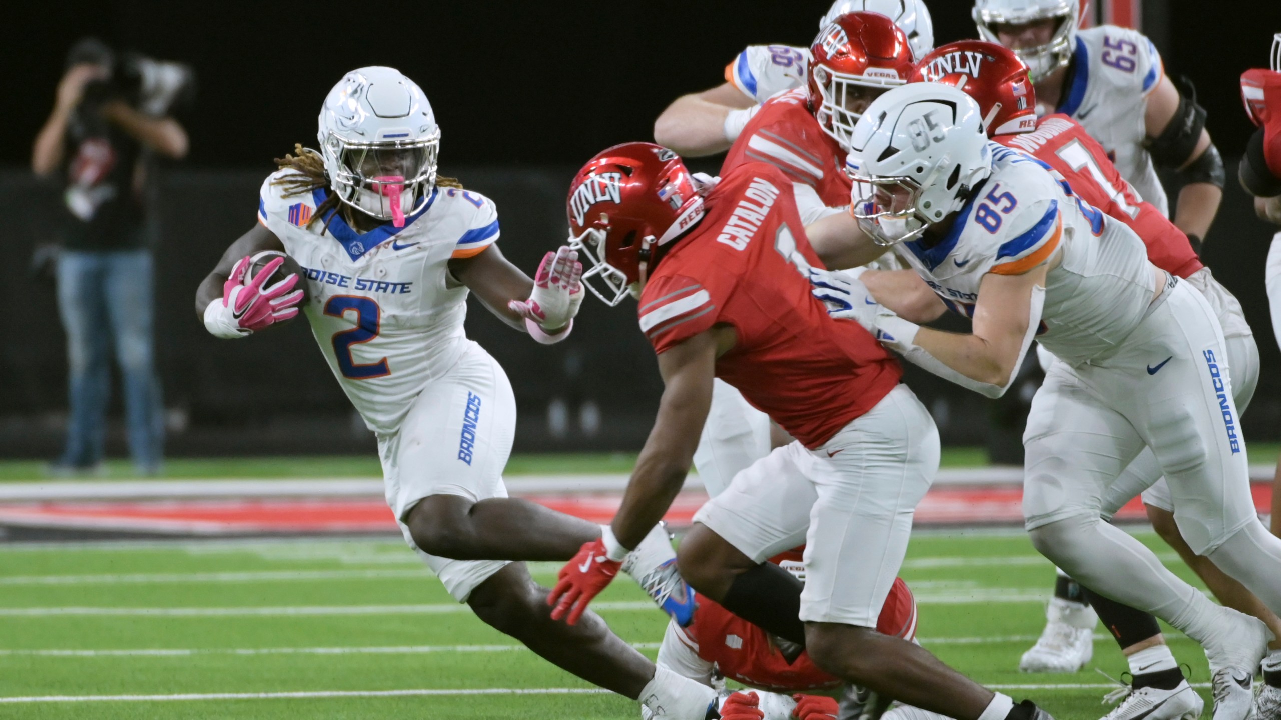 Boise State running back Ashton Jeanty (2) keeps UNLV defensive back Jalen Catalon (1) away during the first half of an NCAA college football game Friday, Oct. 25, 2024, in Las Vegas. (AP Photo/Sam Morris)