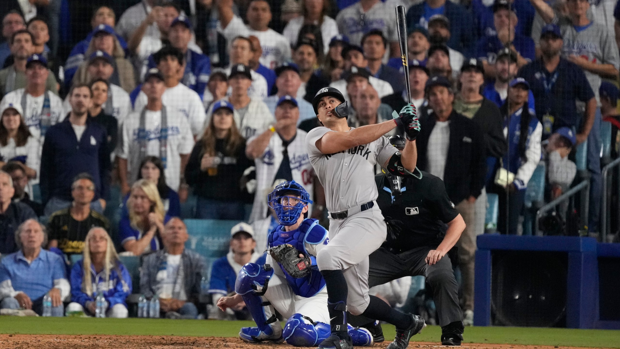 New York Yankees' Giancarlo Stanton watches his two-run home during the sixth inning in Game 1 of the baseball World Series against the Los Angeles Dodgers, Friday, Oct. 25, 2024, in Los Angeles. (AP Photo/Mark J. Terrill)