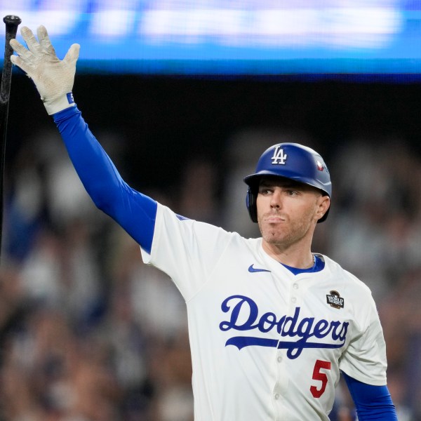 Los Angeles Dodgers' Freddie Freeman celebrates his walk-off grand slam home run against the New York Yankees during the 10th inning in Game 1 of the baseball World Series, Friday, Oct. 25, 2024, in Los Angeles. (AP Photo/Ashley Landis)