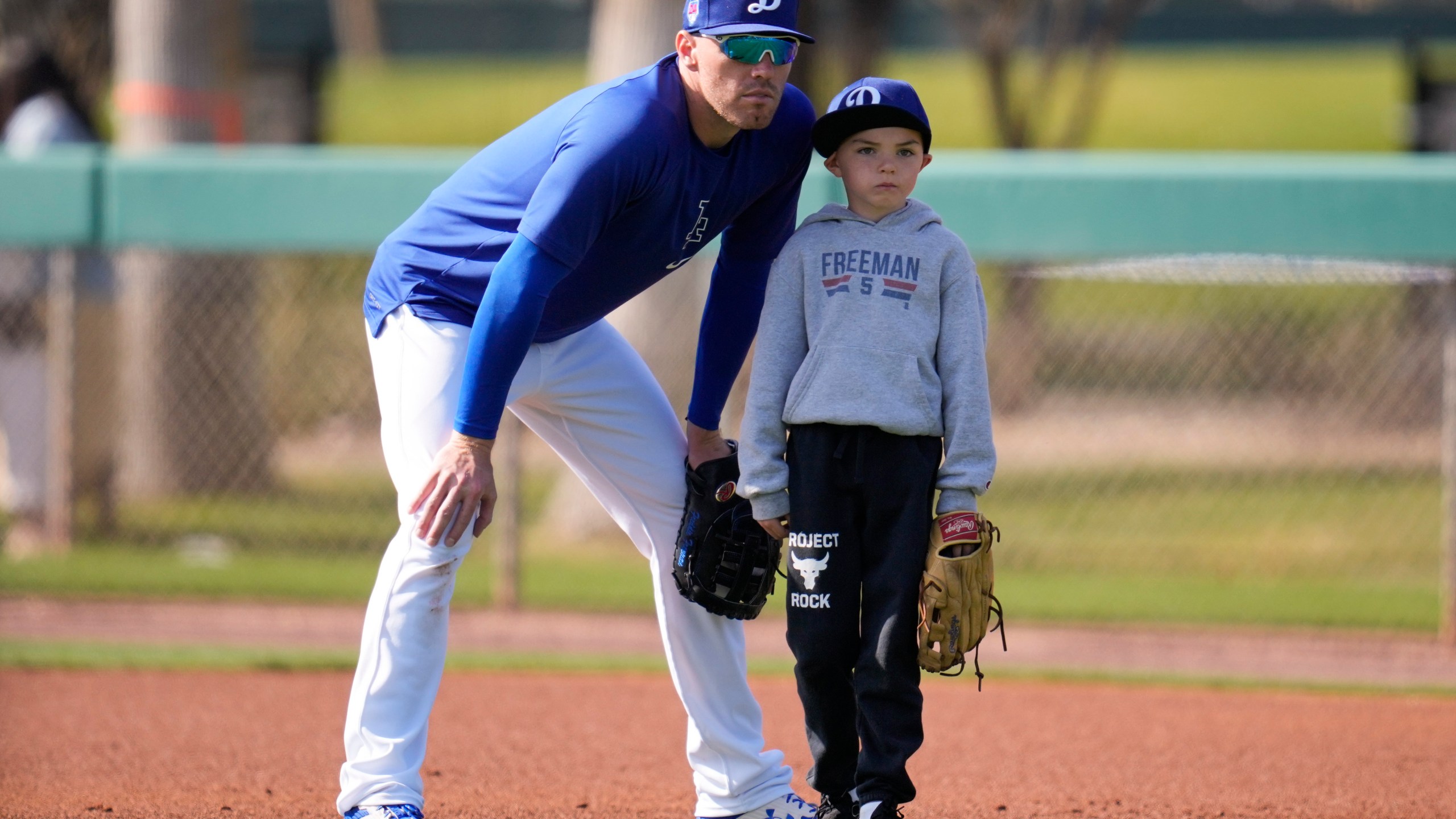 FILE - Los Angeles Dodgers first baseman Freddie Freeman, left, and his son Charlie, right, participate in spring training baseball workouts at Camelback Ranch in Phoenix, Feb. 18, 2024. (AP Photo/Ashley Landis, File)