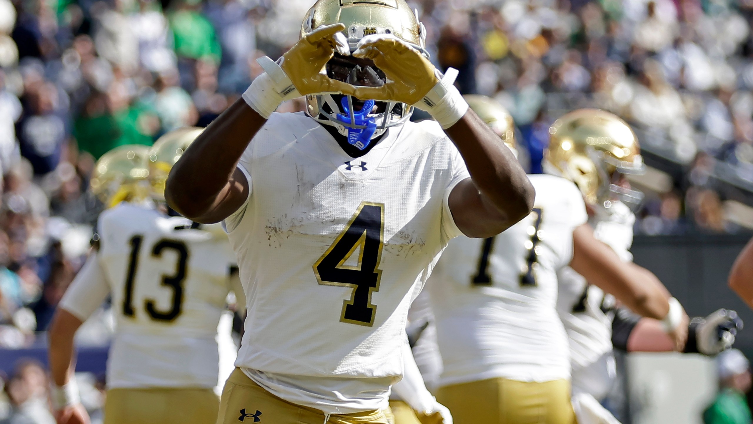 Notre Dame running back Jeremiyah Love (4) reacts after scoring a touchdown during the first half of an NCAA college football game against Navy Saturday, Oct. 26, 2024, in East Rutherford, N.J. (AP Photo/Adam Hunger)