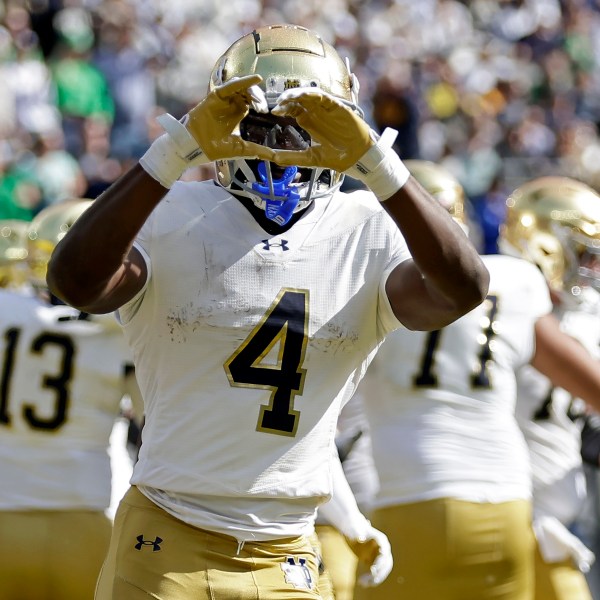 Notre Dame running back Jeremiyah Love (4) reacts after scoring a touchdown during the first half of an NCAA college football game against Navy Saturday, Oct. 26, 2024, in East Rutherford, N.J. (AP Photo/Adam Hunger)