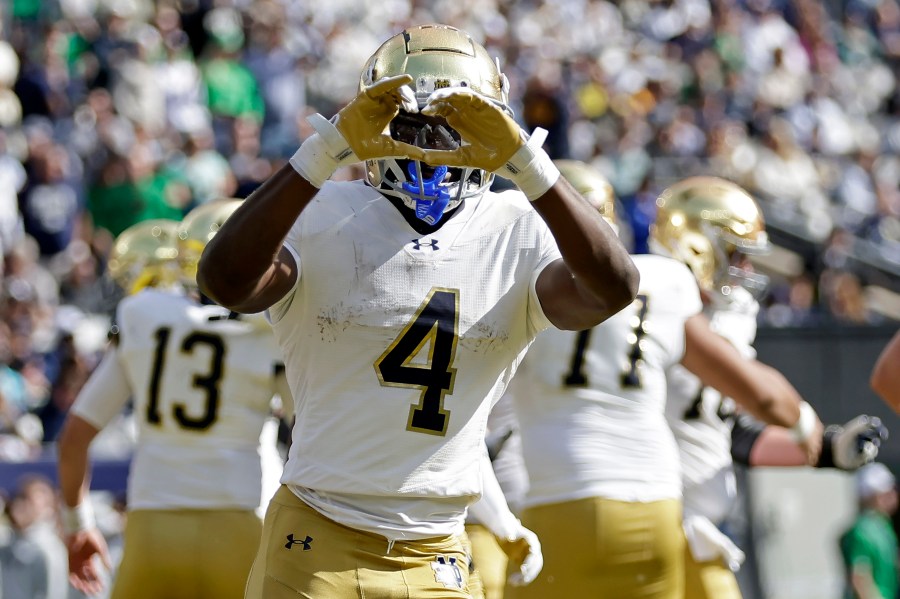 Notre Dame running back Jeremiyah Love (4) reacts after scoring a touchdown during the first half of an NCAA college football game against Navy Saturday, Oct. 26, 2024, in East Rutherford, N.J. (AP Photo/Adam Hunger)