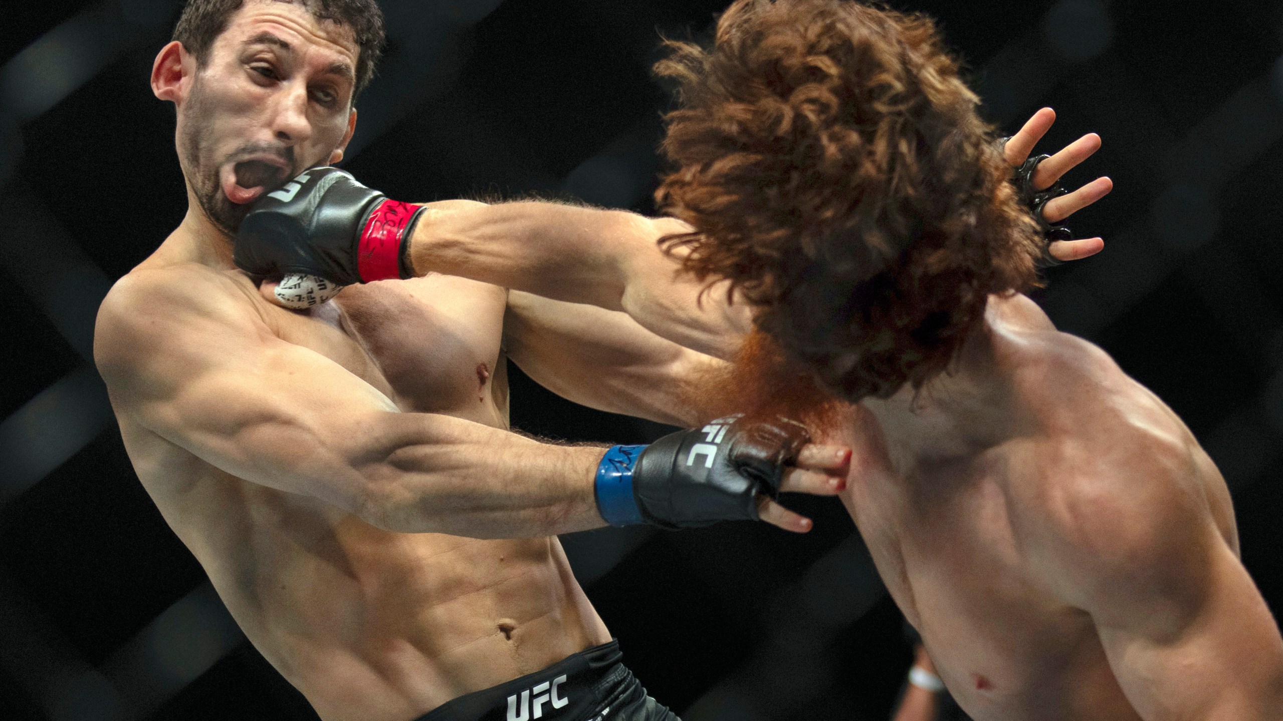 Shara Magomedov, right, punches Armen Petrosyan during a middleweight mixed martial arts bout at UFC Fight Night on Saturday, Oct. 26, 2024, in Abu Dhabi, United Arab Emirates. (AP Photo/Altaf Qadri)