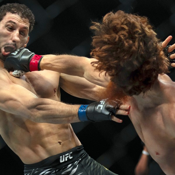 Shara Magomedov, right, punches Armen Petrosyan during a middleweight mixed martial arts bout at UFC Fight Night on Saturday, Oct. 26, 2024, in Abu Dhabi, United Arab Emirates. (AP Photo/Altaf Qadri)