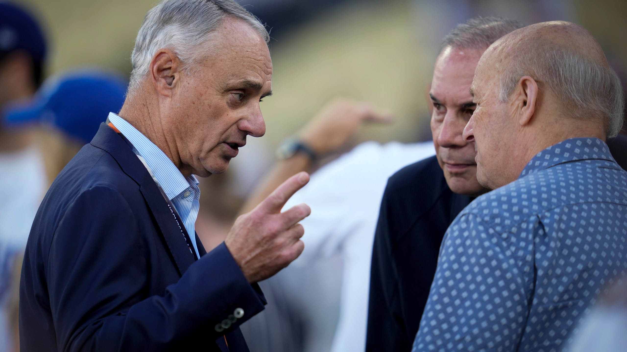 Commissioner of Major League Baseball, Rob Manfred talks on the field before Game 2 of the baseball World Series between the Los Angeles Dodgers and the New York Yankees, Saturday, Oct. 26, 2024, in Los Angeles. (AP Photo/Ashley Landis)