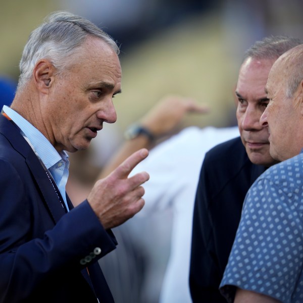 Commissioner of Major League Baseball, Rob Manfred talks on the field before Game 2 of the baseball World Series between the Los Angeles Dodgers and the New York Yankees, Saturday, Oct. 26, 2024, in Los Angeles. (AP Photo/Ashley Landis)