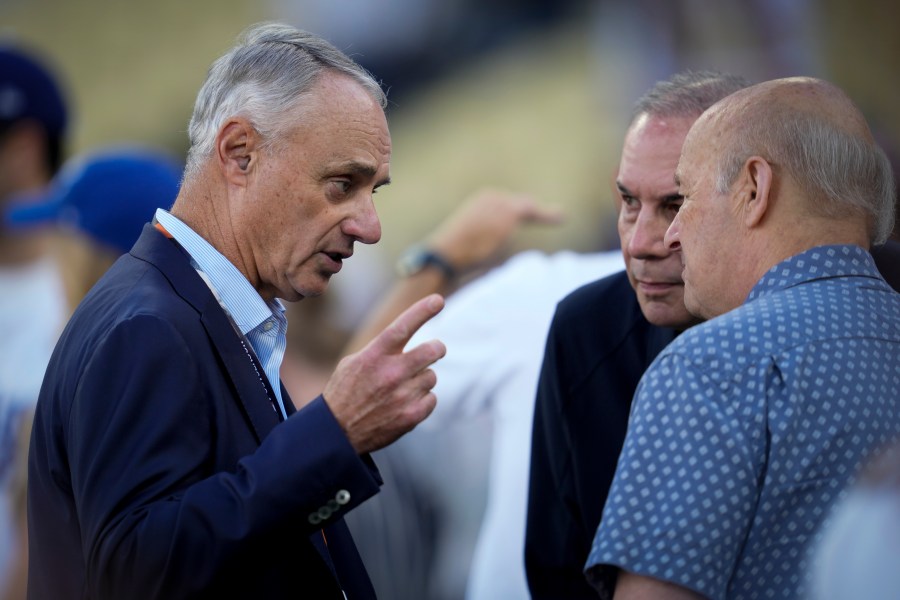 Commissioner of Major League Baseball, Rob Manfred talks on the field before Game 2 of the baseball World Series between the Los Angeles Dodgers and the New York Yankees, Saturday, Oct. 26, 2024, in Los Angeles. (AP Photo/Ashley Landis)