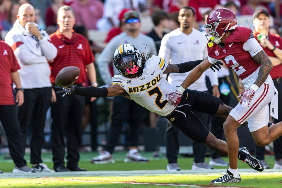 Missouri wide receiver Marquis Johnson, left, misses a pass as Alabama defensive back Zabien Brown, front right, defends during the first half of an NCAA college football game, Saturday, Oct. 26, 2024, in Tuscaloosa, Ala. (AP Photo/Vasha Hunt)