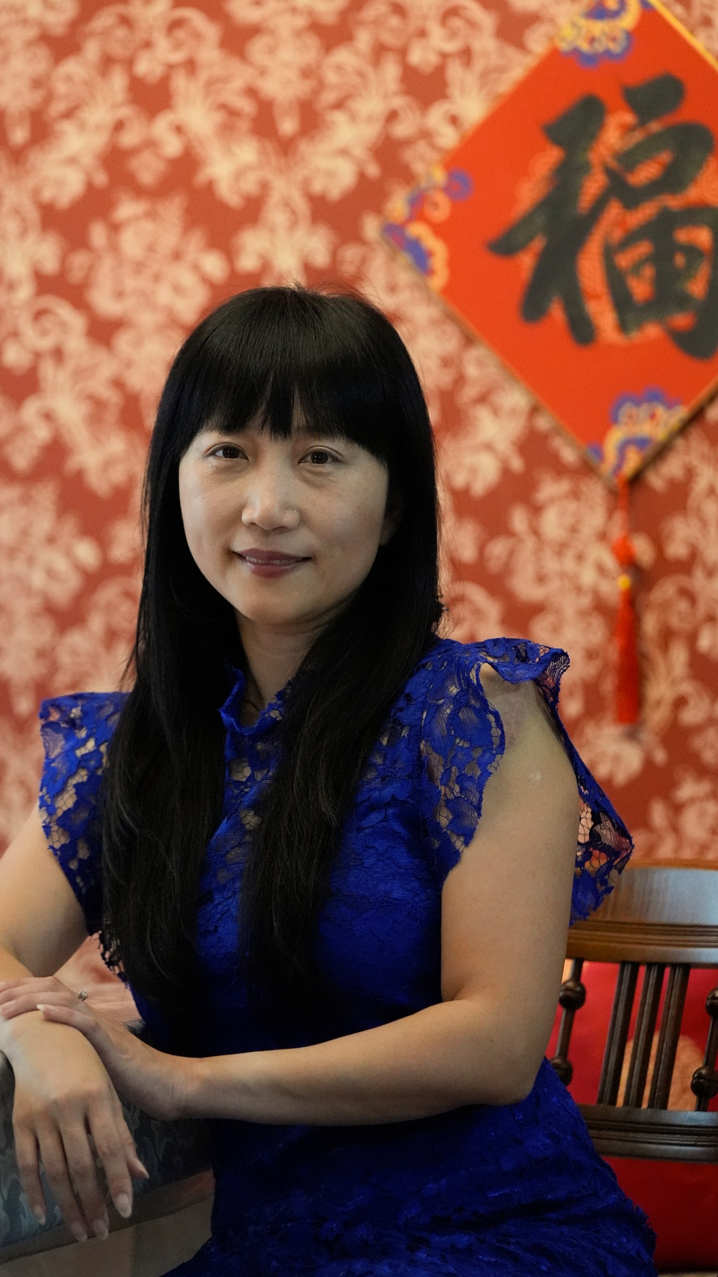 Diana Xue poses for a photo at her home Monday, Oct. 21, 2024, in Orlando, Fla. Xue is a naturalized U.S. citizen born in China who used to vote more Republican but has changed her mind after Florida passed the alien land law. (AP Photo/John Raoux)