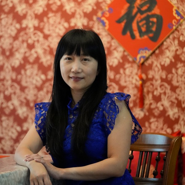 Diana Xue poses for a photo at her home Monday, Oct. 21, 2024, in Orlando, Fla. Xue is a naturalized U.S. citizen born in China who used to vote more Republican but has changed her mind after Florida passed the alien land law. (AP Photo/John Raoux)