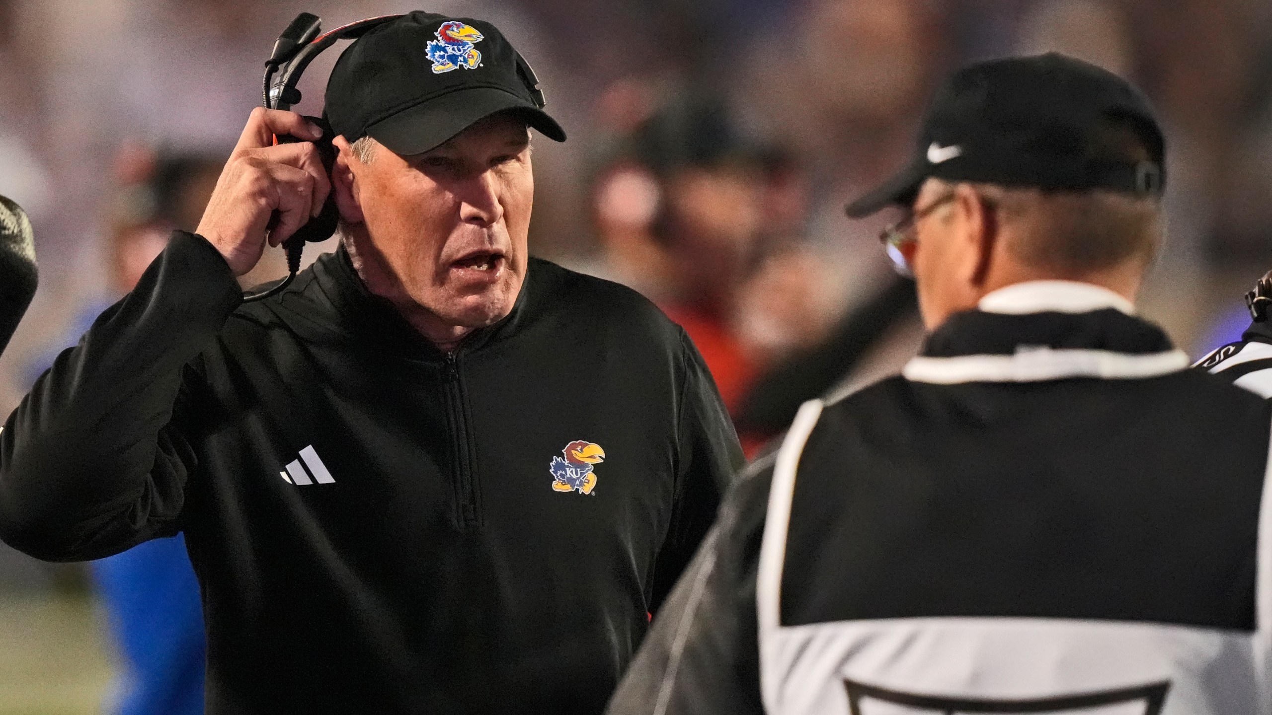 Kansas head coach Lance Leipold talks to an official during the first half of an NCAA college football game against Kansas State Saturday, Oct. 26, 2024, in Manhattan, Kan. (AP Photo/Charlie Riedel)