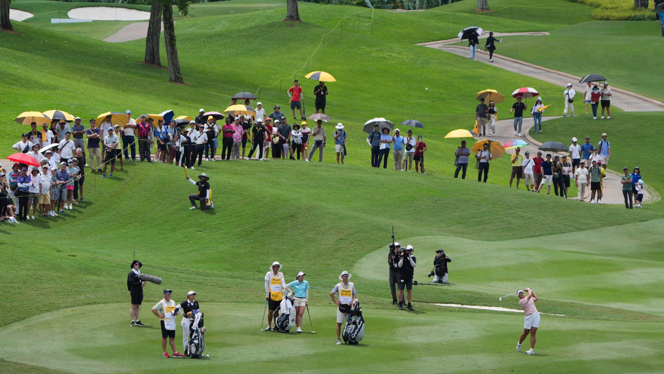 Ryu Haeran of South Korea's, right, watches her fairway shot on the 14th hole during the LPGA Tour's Maybank Championship at Kuala Lumpur Golf and Country club in Kuala Lumpur, Sunday, Oct. 27, 2024. (AP Photo/Vincent Thian)