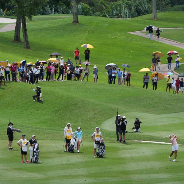 Ryu Haeran of South Korea's, right, watches her fairway shot on the 14th hole during the LPGA Tour's Maybank Championship at Kuala Lumpur Golf and Country club in Kuala Lumpur, Sunday, Oct. 27, 2024. (AP Photo/Vincent Thian)