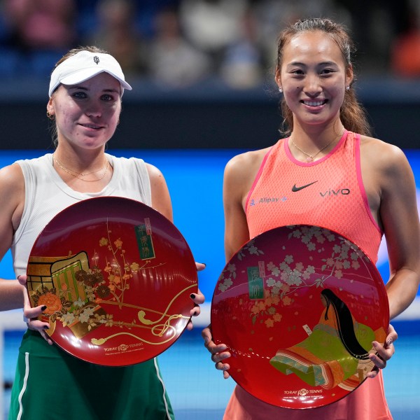 China's Zheng Qinwen, right, and Sofia Kenin of the United States pose with their trophies after winning the first and second place respectively in the Pan Pacific Open women's tennis tournament at Ariake Coliseum, in Tokyo, Sunday, Oct. 27, 2024. (AP Photo/Eugene Hoshiko)