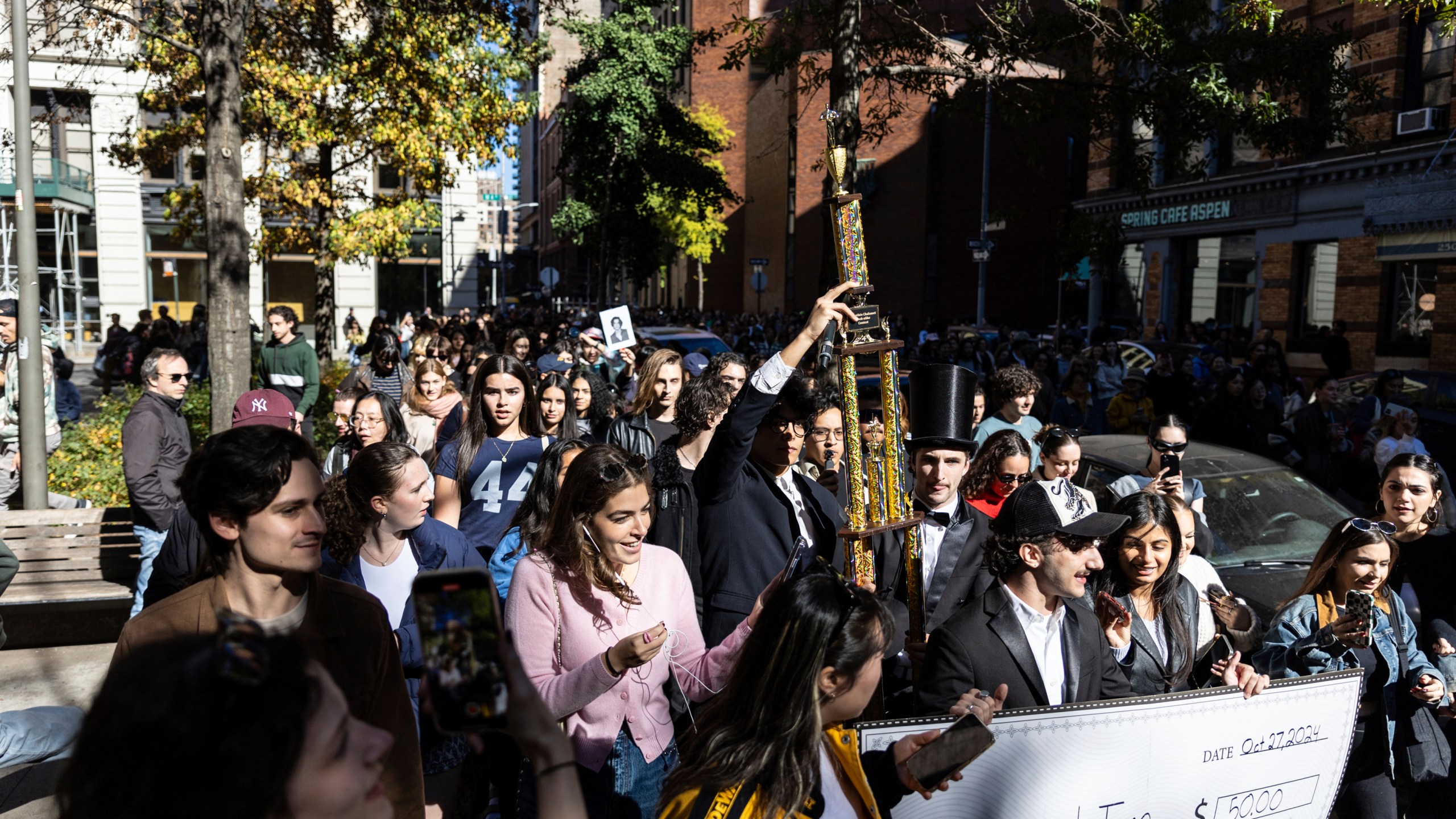 The trophy for the Timothee Chalamet lookalike contest is paraded through the street as the contest organizers move the event to a new location near Washington Square Park, Sunday, Oct. 27, 2024, in New York. (AP Photo/Stefan Jeremiah)