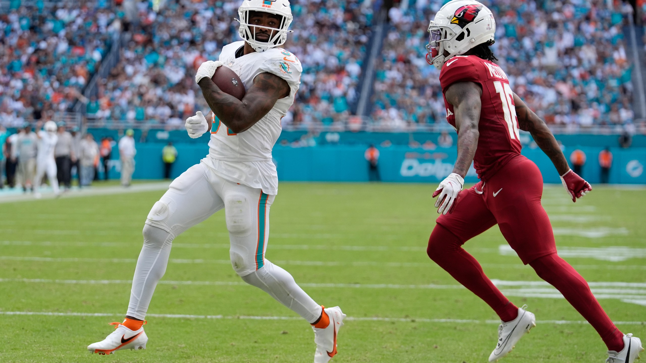 Miami Dolphins running back Raheem Mostert (31) scores a touchdown during the second half of an NFL football game against the Arizona Cardinals, Sunday, Oct. 27, 2024, in Miami Gardens, Fla. (AP Photo/Rebecca Blackwell)