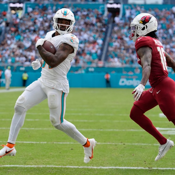 Miami Dolphins running back Raheem Mostert (31) scores a touchdown during the second half of an NFL football game against the Arizona Cardinals, Sunday, Oct. 27, 2024, in Miami Gardens, Fla. (AP Photo/Rebecca Blackwell)