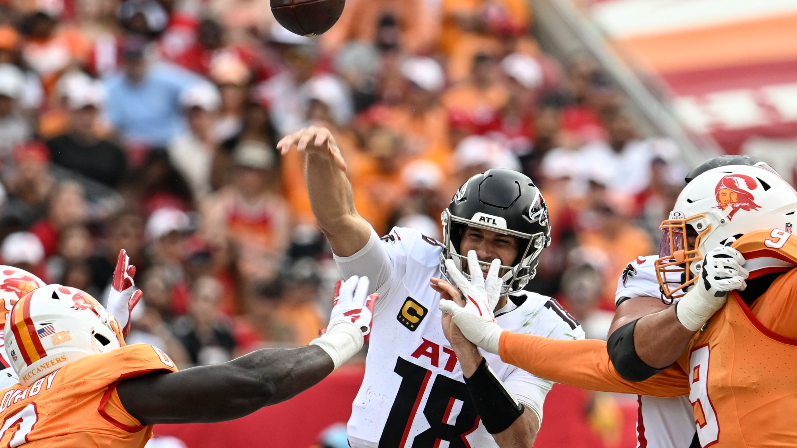 Atlanta Falcons quarterback Kirk Cousins (18) works under pressure against the Tampa Bay Buccaneers during the first half of an NFL football game, Sunday, Oct. 27, 2024, in Tampa. (AP Photo/Jason Behnken)