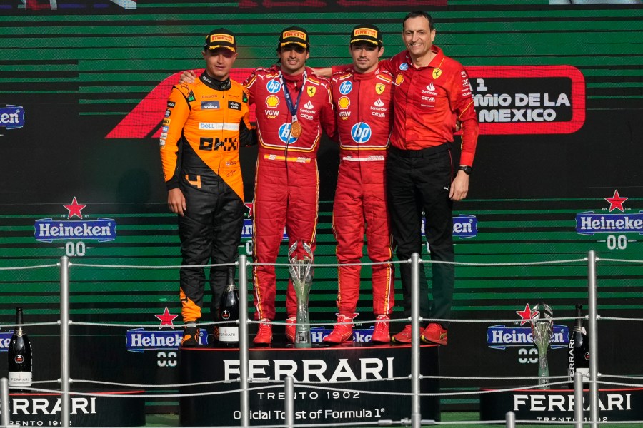 From left, McLaren driver Lando Norris of Britain, second place, Ferrari driver Carlos Sainz of Spain, first place, Ferrari driver Charles Leclerc of Monaco, third place, and Riccardo Adami of Ferrari pose on the podium for the Formula One Mexico Grand Prix auto race at the Hermanos Rodriguez racetrack in Mexico City, Sunday, Oct. 27, 2024. (AP Photo/Eduardo Verdugo)