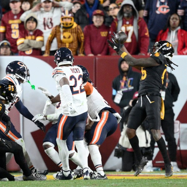 Washington Commanders wide receiver Noah Brown (85) catches a 52-yard touchdown pass in the end zone as time expires to give the Commanders an 18-15 win over the Chicago Bears in an NFL football game Sunday, Oct. 27, 2024, in Landover, Md. (AP Photo/Nick Wass)