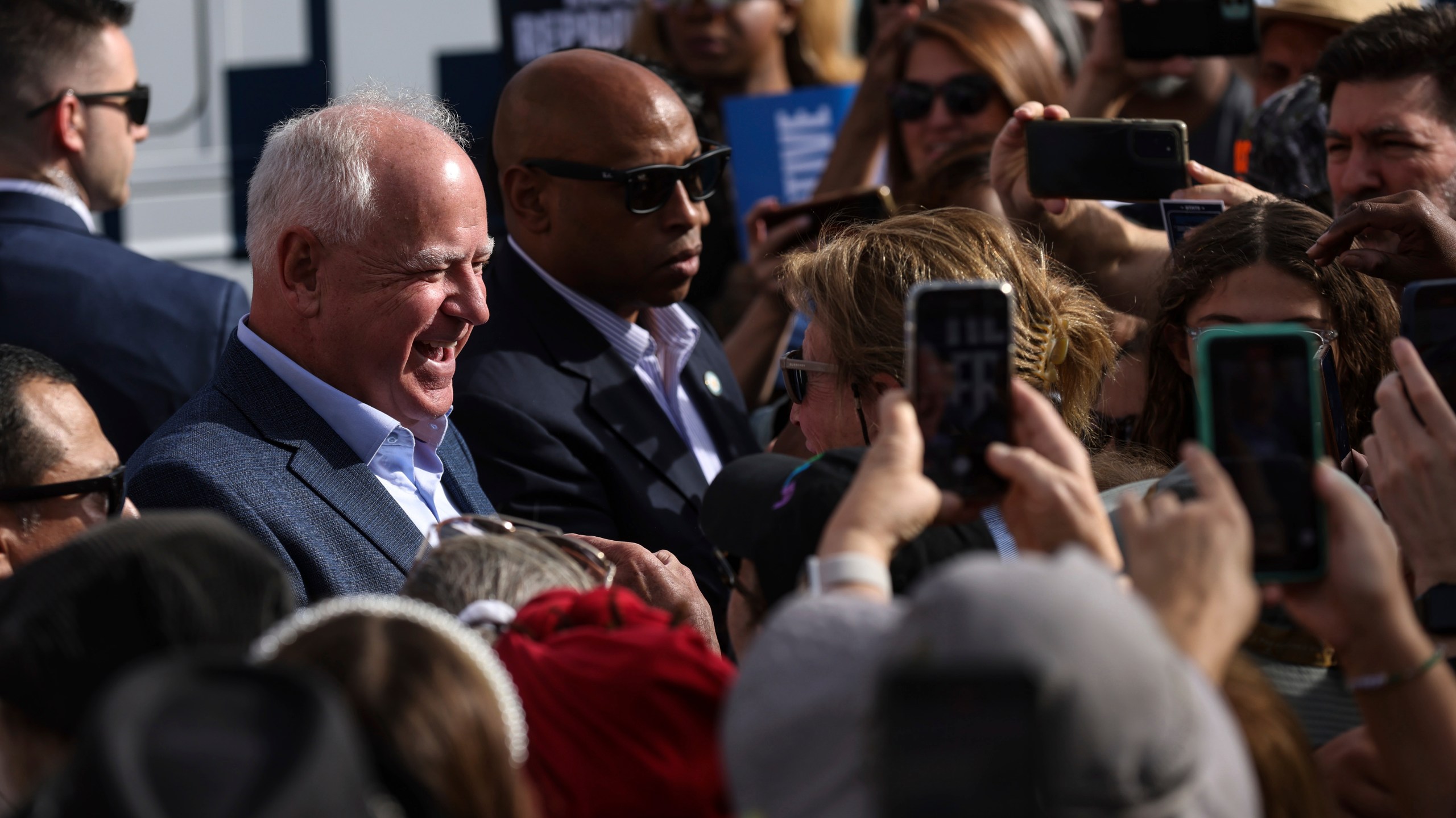 Democratic vice presidential nominee Tim Walz greets members of the crowd at a Harris-Walz campaign's "Fighting for Reproductive Freedom" bus tour stop and canvass kick-off event outside their campaign office in Henderson, Sunday, Oct. 27, 2024. (Rachel Aston/Las Vegas Review-Journal via AP)