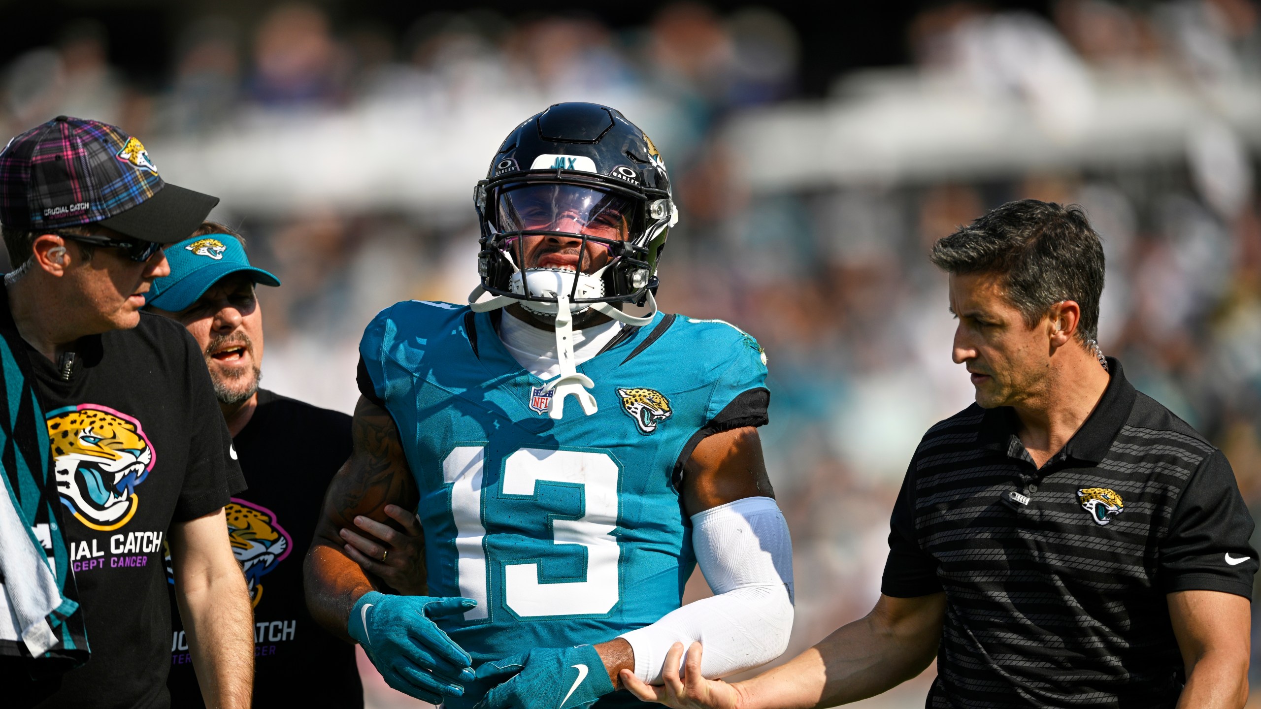 Jacksonville Jaguars' Christian Kirk is helped off the field during the second half of an NFL football game against the Green Bay Packers Sunday, Oct. 27, 2024, in Jacksonville, Fla. (AP Photo/Phelan M. Ebenhack)