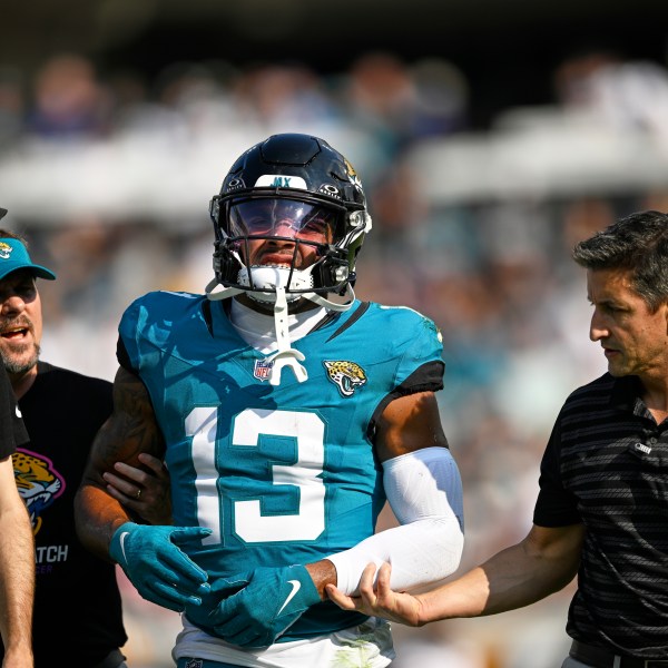 Jacksonville Jaguars' Christian Kirk is helped off the field during the second half of an NFL football game against the Green Bay Packers Sunday, Oct. 27, 2024, in Jacksonville, Fla. (AP Photo/Phelan M. Ebenhack)