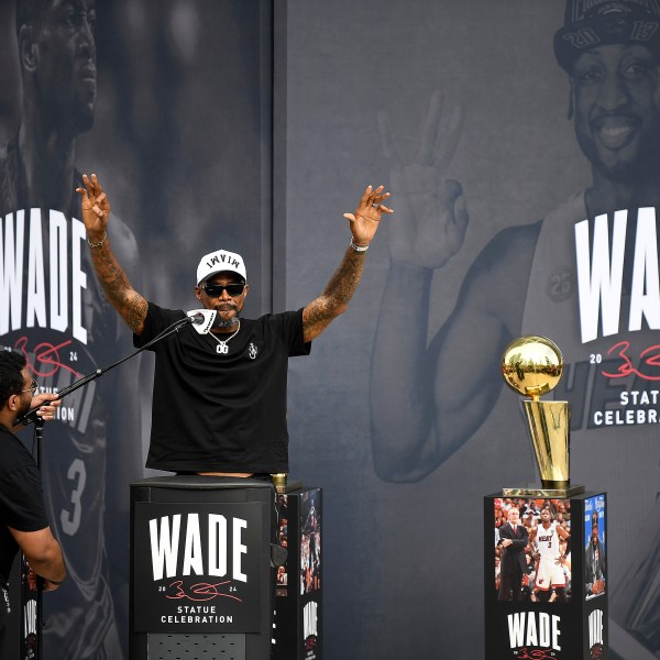 Former Miami Heat NBA basketball player Udonis Haslem, second from left, speaks during a statue unveiling ceremony for former teammate Dwyane Wade outside the Kaseya Center, Sunday, Oct. 27, 2024, in Miami, Fla. (AP Photo/Michael Laughlin)