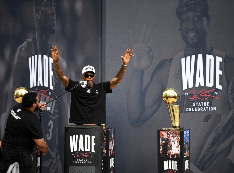 Former Miami Heat NBA basketball player Udonis Haslem, second from left, speaks during a statue unveiling ceremony for former teammate Dwyane Wade outside the Kaseya Center, Sunday, Oct. 27, 2024, in Miami, Fla. (AP Photo/Michael Laughlin)