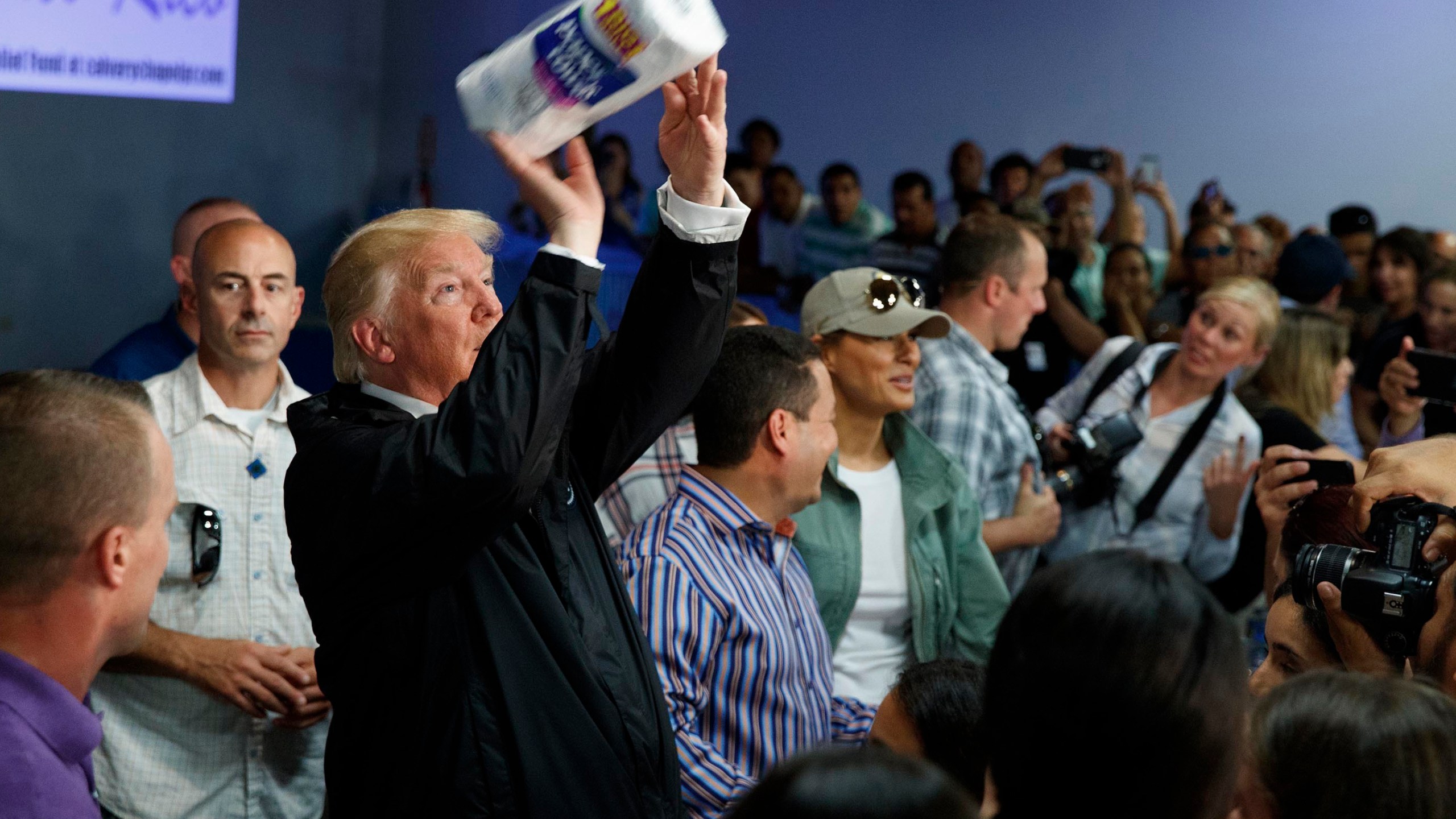 FILE - President Donald Trump tosses paper towels into a crowd at Calvary Chapel in Guaynabo, Puerto Rico, Oct. 3, 2017. (AP Photo/Evan Vucci, File)